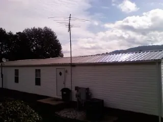 New metal roof on a single wide mobile home with a TV antenna in Jetson